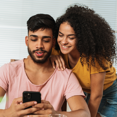 Two people using a phone
